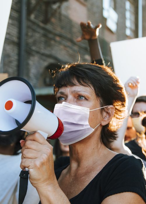 Diverse people wearing mask protesting during COVID-19 pandemic